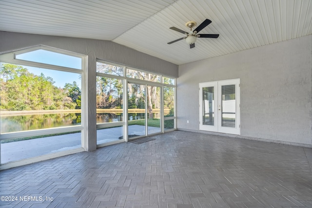 unfurnished sunroom with a water view, ceiling fan, and lofted ceiling