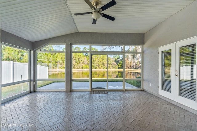 unfurnished sunroom featuring ceiling fan, french doors, plenty of natural light, lofted ceiling, and a water view