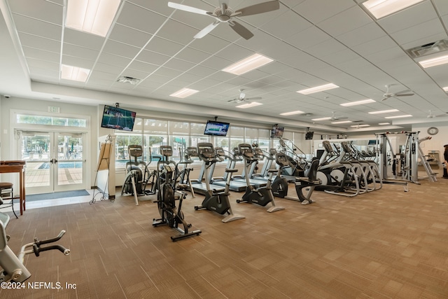 gym featuring carpet flooring, ceiling fan, and french doors