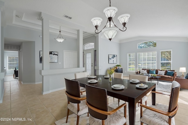 dining area featuring crown molding, light tile patterned floors, vaulted ceiling, and an inviting chandelier