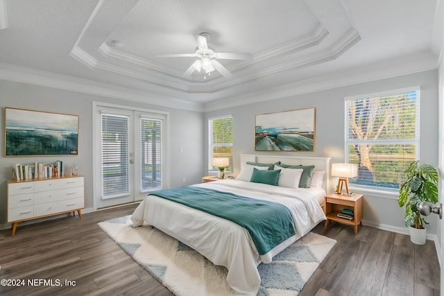 bedroom with multiple windows, ceiling fan, dark hardwood / wood-style flooring, and access to exterior