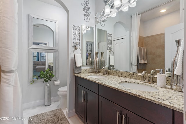 bathroom featuring tile patterned flooring, vanity, and toilet