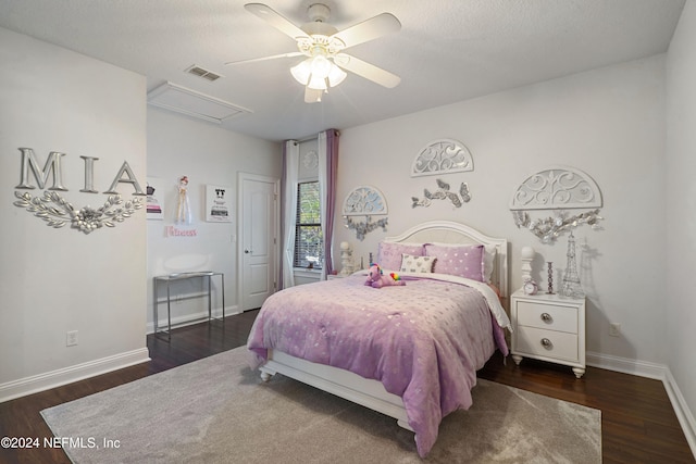 bedroom with ceiling fan, dark wood-type flooring, and a textured ceiling