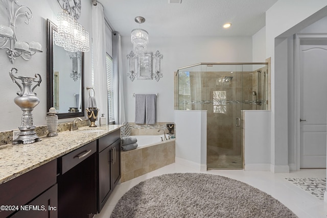 bathroom featuring vanity, tile patterned floors, separate shower and tub, a textured ceiling, and a notable chandelier