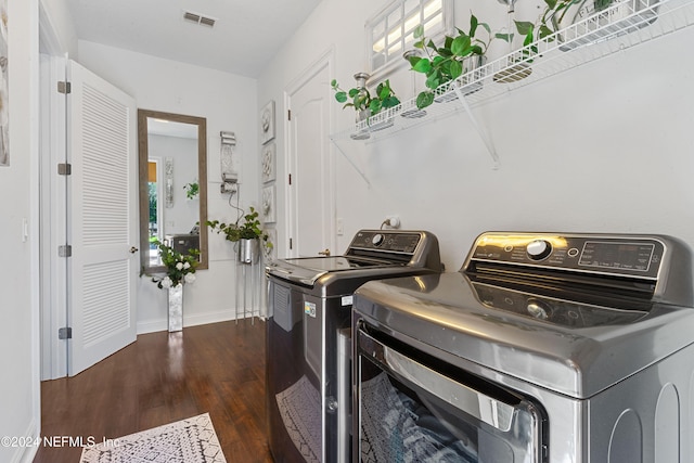 laundry room featuring independent washer and dryer and dark hardwood / wood-style floors