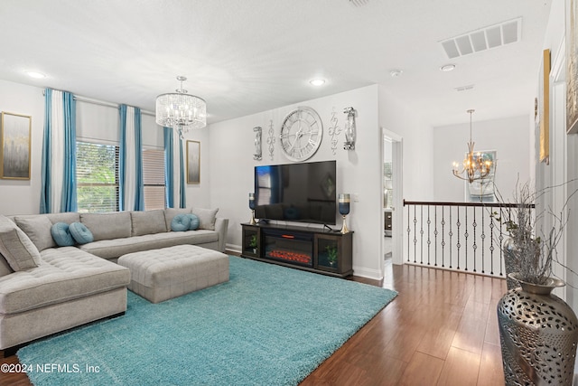 living room featuring hardwood / wood-style floors and a chandelier