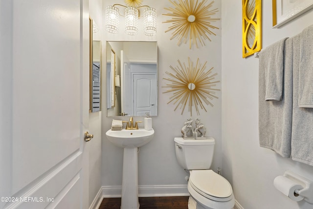 bathroom featuring hardwood / wood-style floors and toilet