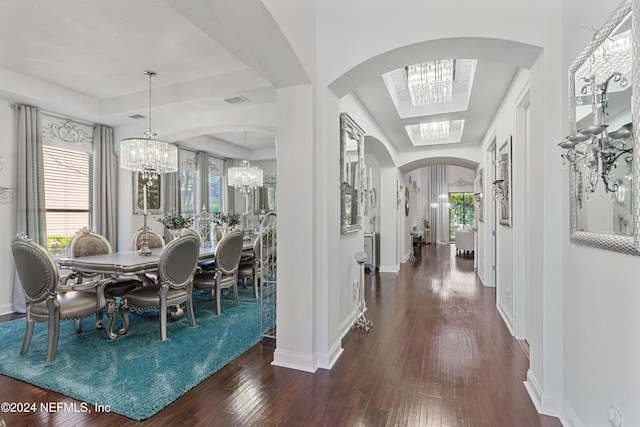 dining area featuring a chandelier and dark wood-type flooring