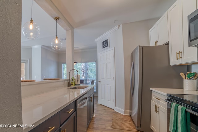 kitchen with dishwasher, white cabinets, sink, hanging light fixtures, and light wood-type flooring