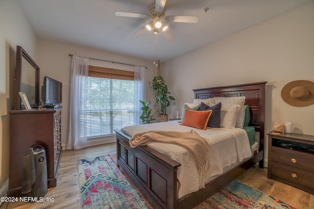 bedroom with light hardwood / wood-style floors and ceiling fan