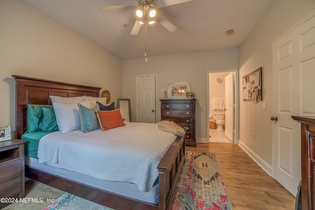 bedroom with light hardwood / wood-style floors, ceiling fan, and ensuite bathroom