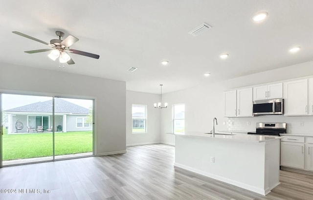 kitchen with sink, light wood-type flooring, white cabinetry, and stainless steel appliances