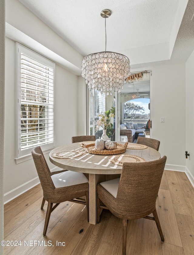 415 N Ocean Grande Dr Unit 101, Ponte Vedra Beach, FL 32082 - dining space with light wood-style flooring, baseboards, and a chandelier
