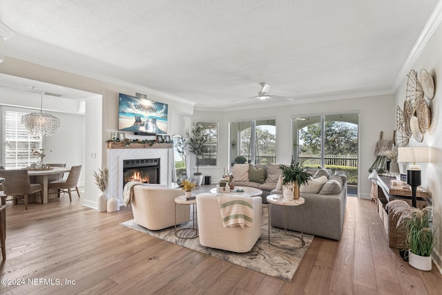 415 N Ocean Grande Dr Unit 101, Ponte Vedra Beach, FL 32082 - living room with a ceiling fan, ornamental molding, a glass covered fireplace, wood finished floors, and a textured ceiling