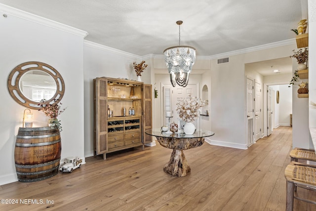 415 N Ocean Grande Dr Unit 101, Ponte Vedra Beach, FL 32082 - dining room featuring a chandelier, hardwood / wood-style floors, ornamental molding, and baseboards