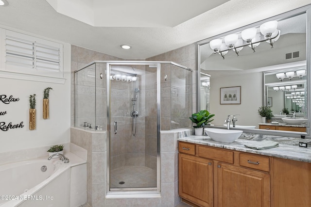 415 N Ocean Grande Dr Unit 101, Ponte Vedra Beach, FL 32082 - bathroom featuring vanity, a garden tub, a stall shower, and a textured ceiling