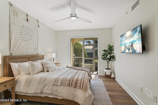 415 N Ocean Grande Dr Unit 101, Ponte Vedra Beach, FL 32082 - bedroom featuring dark wood-type flooring, access to exterior, a textured ceiling, baseboards, and ceiling fan