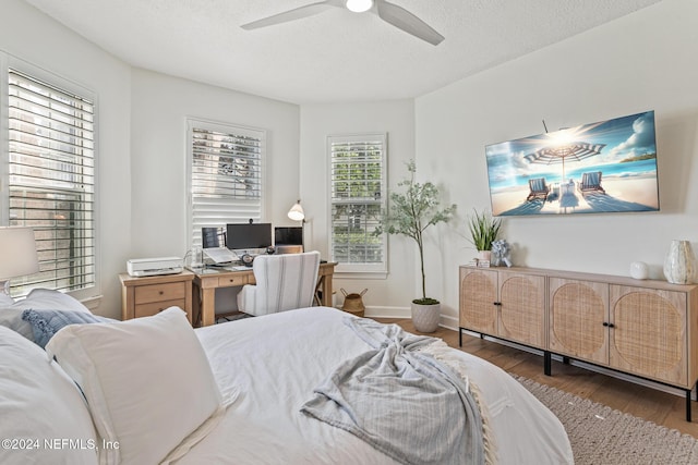 415 N Ocean Grande Dr Unit 101, Ponte Vedra Beach, FL 32082 - bedroom with wood finished floors, a textured ceiling, ceiling fan, and baseboards
