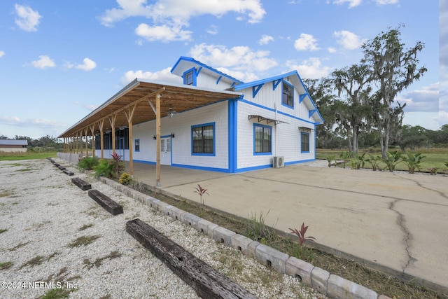 view of side of home with covered porch and cooling unit