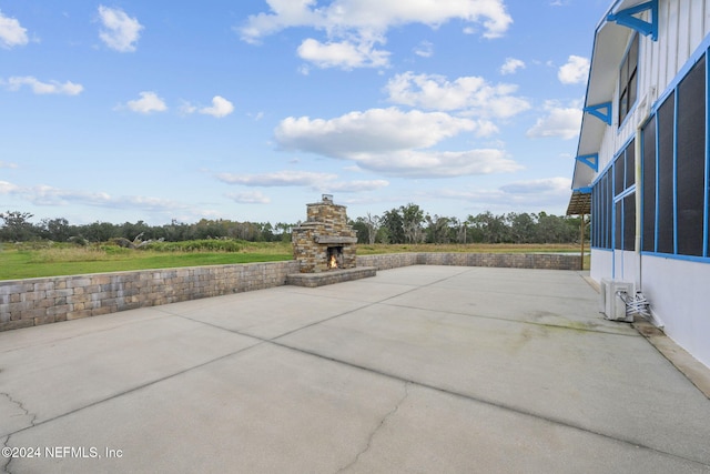 view of patio with an outdoor stone fireplace