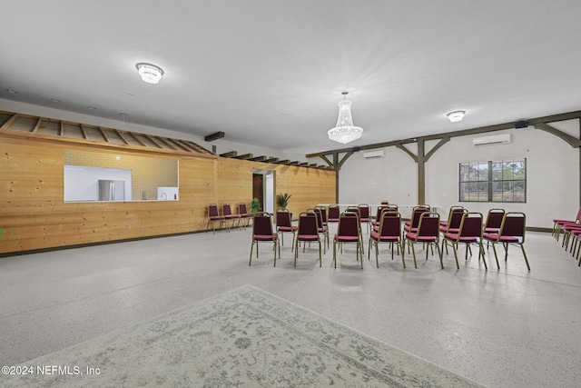 dining room with wood walls and a wall mounted air conditioner