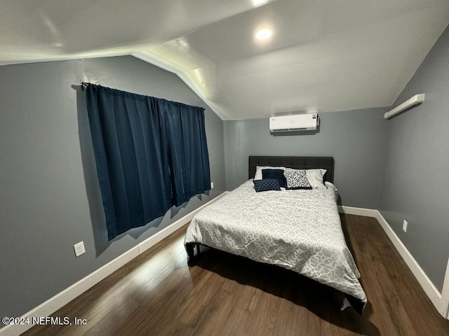 bedroom featuring a wall mounted air conditioner, wood-type flooring, and lofted ceiling