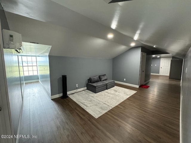 bonus room with an AC wall unit, dark wood-type flooring, and lofted ceiling