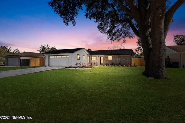 ranch-style house with a lawn and a garage