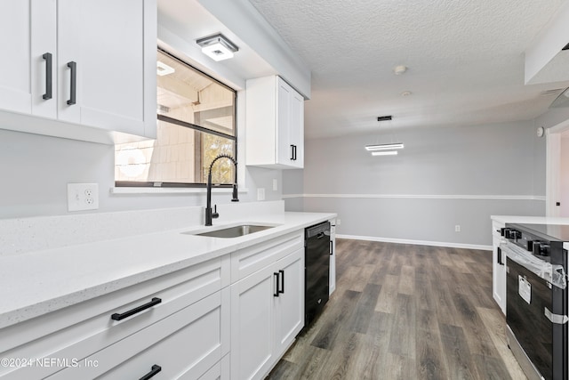 kitchen with sink, dark wood-type flooring, stainless steel stove, black dishwasher, and white cabinets