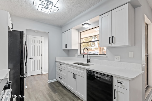 kitchen with white cabinets, sink, dark wood-type flooring, and black appliances