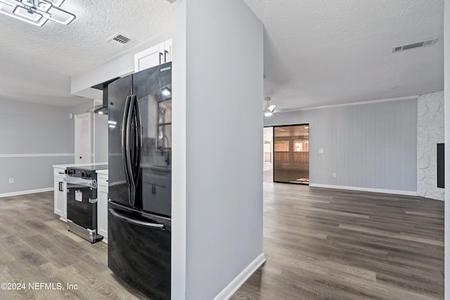 kitchen featuring white cabinetry, black refrigerator, electric range, and hardwood / wood-style floors