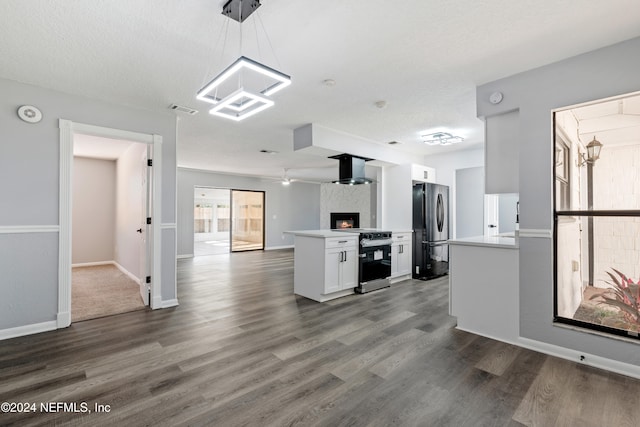 kitchen with pendant lighting, stainless steel electric range, white cabinets, refrigerator, and dark hardwood / wood-style floors