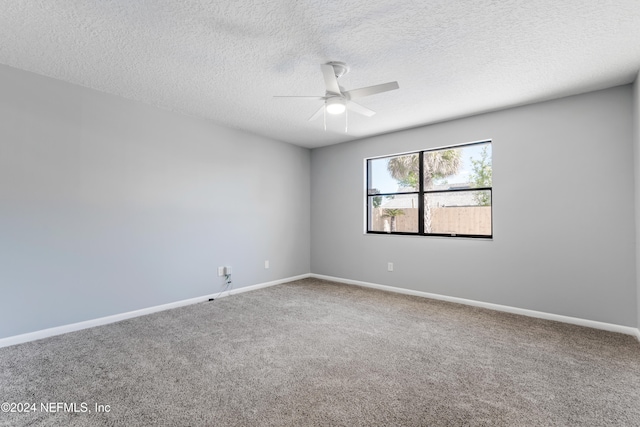 unfurnished room featuring ceiling fan, carpet, and a textured ceiling