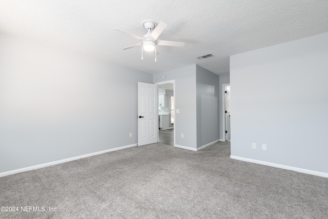 carpeted spare room with ceiling fan and a textured ceiling