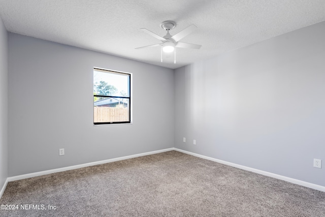 carpeted empty room with a textured ceiling and ceiling fan