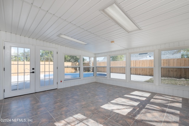 unfurnished sunroom featuring french doors and a wealth of natural light