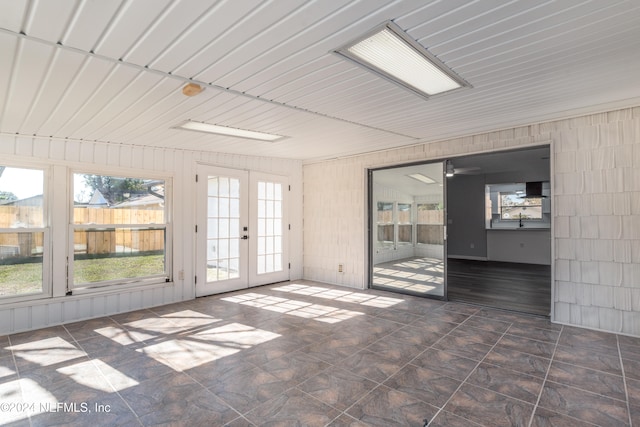 unfurnished sunroom with french doors