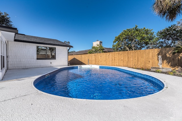 view of swimming pool with a patio