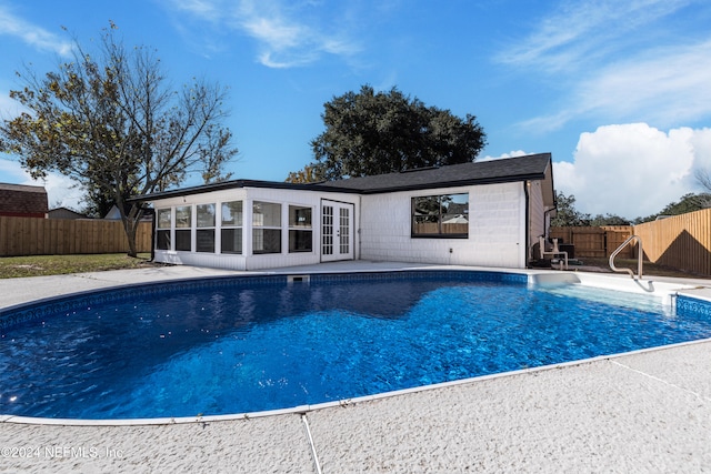 view of pool with french doors