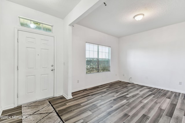 entryway featuring a textured ceiling and hardwood / wood-style flooring