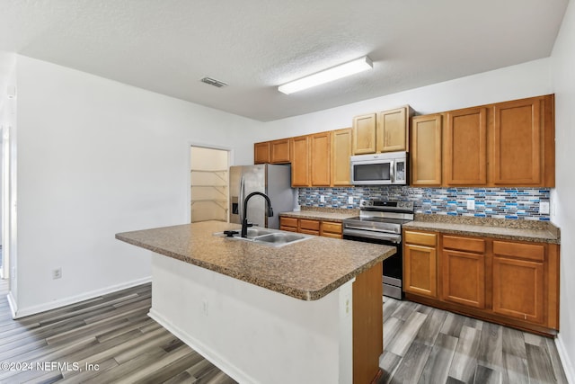 kitchen featuring a textured ceiling, dark hardwood / wood-style flooring, stainless steel appliances, and sink