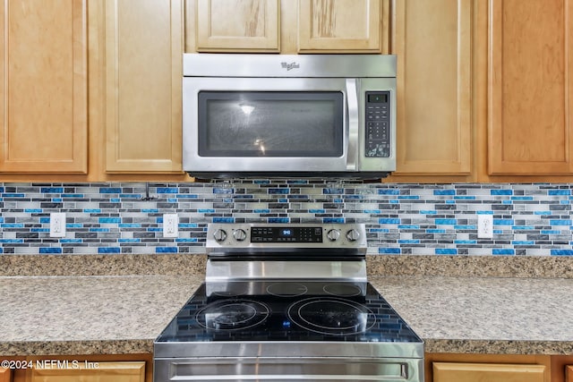 kitchen with tasteful backsplash and stainless steel appliances