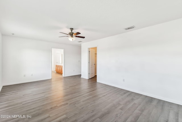 empty room featuring hardwood / wood-style floors and ceiling fan