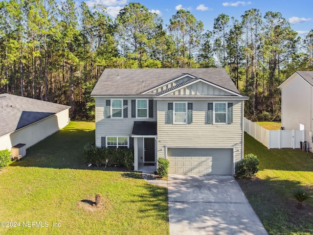 view of front of house with a garage and a front yard