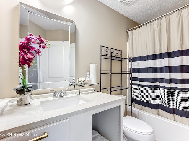 full bathroom with vanity, shower / bath combination with curtain, a textured ceiling, and toilet