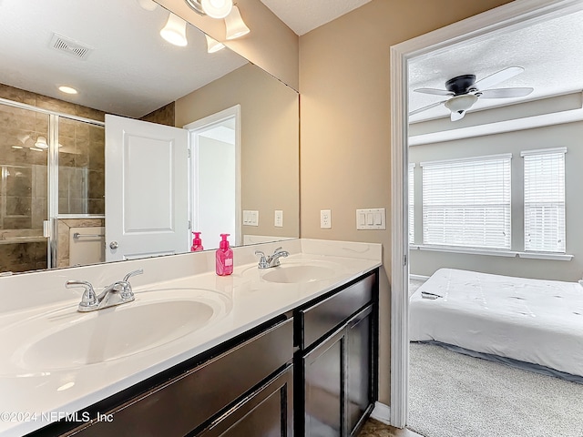 bathroom with walk in shower, a textured ceiling, vanity, and ceiling fan