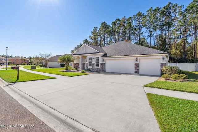 view of front of home with a garage and a front lawn