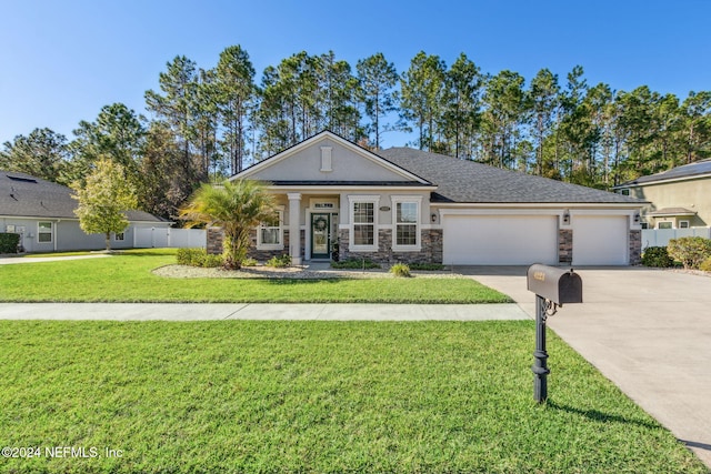 view of front of property with a front yard and a garage