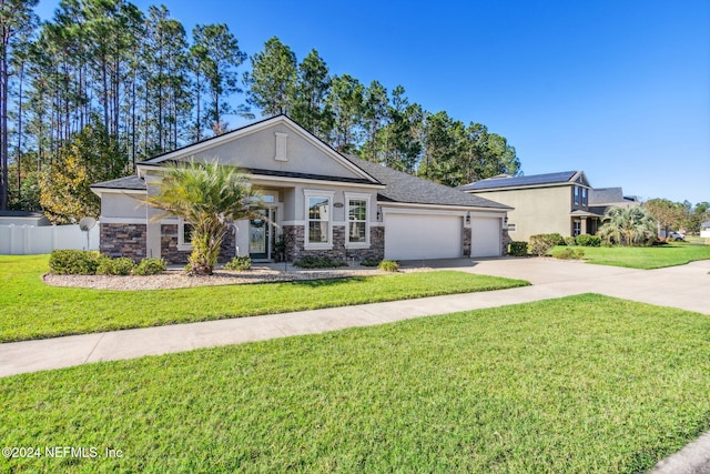 view of front of home with a front yard and a garage