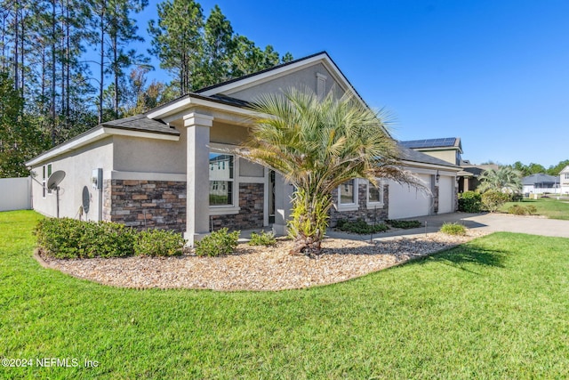 view of front facade featuring a garage and a front lawn